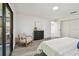 Bedroom features wood-look floors, accent chair, and ensuite door at 2953 Yucca Ct, Palm Harbor, FL 34684