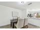 Dining room with view into kitchen with stainless appliances, white cabinets, and lots of natural light at 2953 Yucca Ct, Palm Harbor, FL 34684