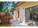 Charming home exterior featuring a stucco facade, cozy patio, and sliding glass door entry at 2953 Yucca Ct, Palm Harbor, FL 34684