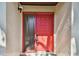 Close up shot of a bright red front door with textured walls at 2953 Yucca Ct, Palm Harbor, FL 34684
