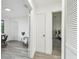 Hallway view leading to bedroom and office space with wood-look flooring at 2953 Yucca Ct, Palm Harbor, FL 34684
