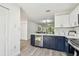 Kitchen featuring stainless steel dishwasher and white countertops, with a view of the living area at 2953 Yucca Ct, Palm Harbor, FL 34684