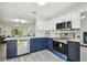 Well-lit kitchen featuring sleek appliances, blue cabinetry, and an open layout to the living area at 2953 Yucca Ct, Palm Harbor, FL 34684