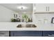 Bright kitchen featuring stainless steel sink and white countertops, open to the living area at 2953 Yucca Ct, Palm Harbor, FL 34684