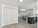 Open-concept living area seamlessly blends the kitchen, dining, and living spaces with light wood floors at 2953 Yucca Ct, Palm Harbor, FL 34684