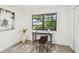 Bright office space with desk, chair, wood-look floors, and natural light from window at 2953 Yucca Ct, Palm Harbor, FL 34684