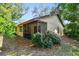 Home exterior features a screened porch surrounded by lush landscaping at 2953 Yucca Ct, Palm Harbor, FL 34684