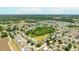 An aerial shot showcases the property's setting within a tranquil community and nearby pond at 3406 Pearl Dove Ln, Plant City, FL 33567