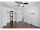 Clean bedroom with a closet, gray walls, wood flooring and door leading to another room at 3406 Pearl Dove Ln, Plant City, FL 33567