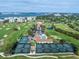 Aerial view of the golf course community, showcasing the tennis courts, pool, and waterfront location at 4 Belleview Blvd # 802, Belleair, FL 33756