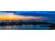 An impressive waterfront view highlights stunning homes with private docks beneath a beautiful sunset sky at 4 Belleview Blvd # 802, Belleair, FL 33756