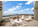 A stunning view of a balcony furnished with comfortable lounge chairs overlooking the water at 4 Belleview Blvd # 802, Belleair, FL 33756