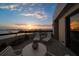 Captivating balcony setting with lounge chairs, table, and decor with a stunning sunset and skyline view at 4 Belleview Blvd # 802, Belleair, FL 33756