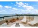 Spacious balcony with lounge chairs overlooking a stunning cityscape and waterfront views at 4 Belleview Blvd # 802, Belleair, FL 33756