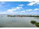 Wide angle balcony view of water, cityscape, and cloud-filled sky at 4 Belleview Blvd # 802, Belleair, FL 33756