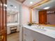 The bathroom features white cabinets, gold hardware, and a unique star pattern wallpaper at 4 Belleview Blvd # 802, Belleair, FL 33756