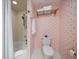 Bathroom featuring shower/tub with gold fixtures, toilet and unique star patterned wallpaper, and towel rack at 4 Belleview Blvd # 802, Belleair, FL 33756