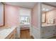 This bathroom has a unique pink lattice pattern wallpaper with a view to an outdoor balcony at 4 Belleview Blvd # 802, Belleair, FL 33756