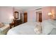 Bedroom featuring an inviting armchair, patterned wall paper, and a comfortable bed with patterned floral pillows at 4 Belleview Blvd # 802, Belleair, FL 33756