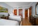 Tasteful bedroom with twin beds, hardwood floors, beautiful doors, and closet space at 4 Belleview Blvd # 802, Belleair, FL 33756