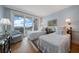 Bright bedroom with hardwood floors, two beds, a balcony with a view, and designer touches at 4 Belleview Blvd # 802, Belleair, FL 33756