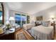 Well-lit bedroom showcasing twin beds, balcony access, hardwood flooring, and designer details at 4 Belleview Blvd # 802, Belleair, FL 33756