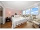 Serene bedroom with a cozy bed, patterned wallpaper, and sliding doors to a scenic balcony at 4 Belleview Blvd # 802, Belleair, FL 33756