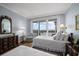 Stylish bedroom featuring balcony access, twin beds, hardwood floors, and designer furniture at 4 Belleview Blvd # 802, Belleair, FL 33756