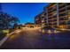 Elegant building entrance featuring a brick drive, manicured landscaping, and covered drop-off area at 4 Belleview Blvd # 802, Belleair, FL 33756