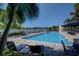 Resort-style pool with lounge chairs, palm trees, and waterfront views creates a relaxing oasis at 4 Belleview Blvd # 802, Belleair, FL 33756