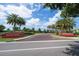 Welcoming entrance to Belleair Country Club featuring lush landscaping, palm trees, and brick signage at 4 Belleview Blvd # 802, Belleair, FL 33756