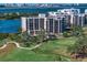 Beautiful multi-story building, lush landscaping and golf course views on a sunny day by the water at 4 Belleview Blvd # 802, Belleair, FL 33756