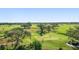 Scenic golf course featuring mature trees, manicured greens, and golfers enjoying a round at 4 Belleview Blvd # 802, Belleair, FL 33756
