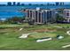 Beautiful golf course and a multi-story residential building overlooking the bay on a clear, sunny day at 4 Belleview Blvd # 802, Belleair, FL 33756