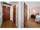 Hallway showcasing multiple doors leading to different rooms within the house, with hardwood floors at 4 Belleview Blvd # 802, Belleair, FL 33756