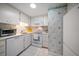 Cozy kitchen features white appliances, tile flooring, and classic cabinetry at 4 Belleview Blvd # 802, Belleair, FL 33756