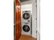 Laundry area showcasing stacked washer and dryer and wood door at 4 Belleview Blvd # 802, Belleair, FL 33756
