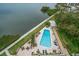 Aerial view of the geometric pool and lounge chairs near the bay and landscaped grounds at 4 Belleview Blvd # 802, Belleair, FL 33756