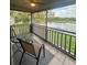 Balcony features table and chairs overlooking a lake view with greenery in the distance at 4022 Cortez Dr # A, Tampa, FL 33614