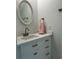 Updated bathroom with white vanity, marble countertop, and elegant round mirror at 4022 Cortez Dr # A, Tampa, FL 33614