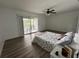 Bright bedroom with wood floors, ceiling fan, and balcony offering scenic outdoor views at 4022 Cortez Dr # A, Tampa, FL 33614
