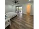 Bedroom with modern hard wood floors and sliding glass doors to balcony with a lake view at 4022 Cortez Dr # A, Tampa, FL 33614