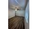 A bedroom with wood-look floors, a ceiling fan and two closets at 4022 Cortez Dr # A, Tampa, FL 33614