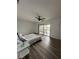 Bright bedroom with wood floors, ceiling fan, and balcony offering scenic outdoor views at 4022 Cortez Dr # A, Tampa, FL 33614