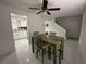 Dining area featuring tile floors, a green table set, and an open view into the adjacent updated kitchen at 4022 Cortez Dr # A, Tampa, FL 33614