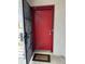Exterior view of a red front door with black screen and welcome mat in an entryway at 4022 Cortez Dr # A, Tampa, FL 33614