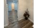 A view of an airy hallway with wood-look floors, and an attractive accent floral arrangement at 4022 Cortez Dr # A, Tampa, FL 33614