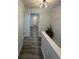 A hallway with modern wood-look floors, freshly painted walls and a decorative light fixture at 4022 Cortez Dr # A, Tampa, FL 33614