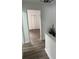 Hallway with wood-style floors leads to a bedroom with double door closet for a clean transition at 4022 Cortez Dr # A, Tampa, FL 33614