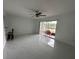 Spacious living room featuring marble floors, a ceiling fan, and sliding doors to a screened-in porch at 4022 Cortez Dr # A, Tampa, FL 33614